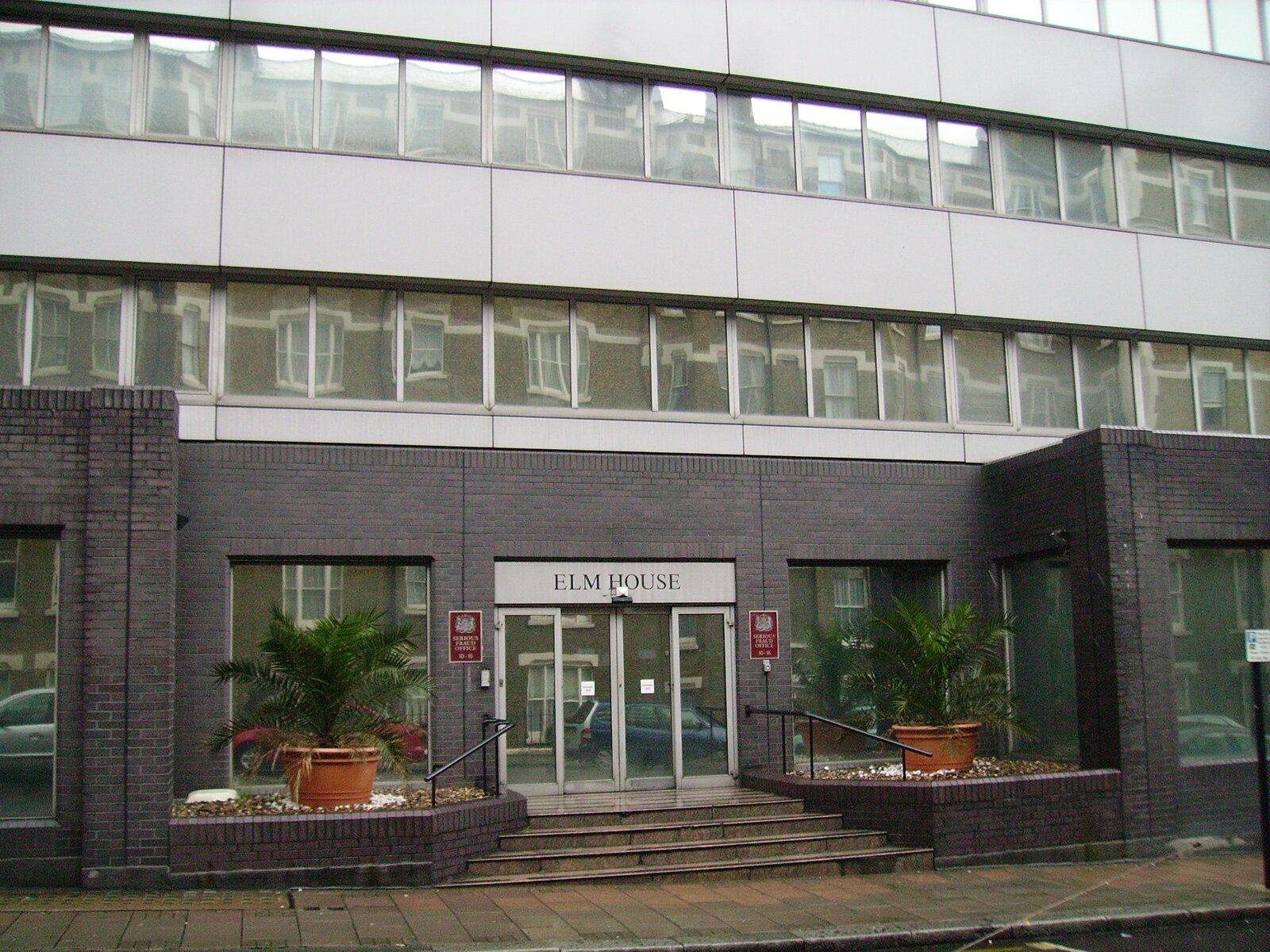 Entrance of Elm House on Elm Street, London, with Serious Fraud Office signs either side of the glass doors
